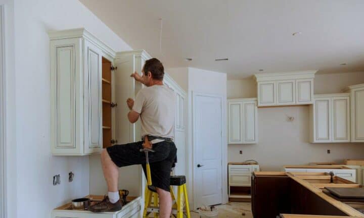 do you need a permit to remodel a kitchen - man remodeling kitchen