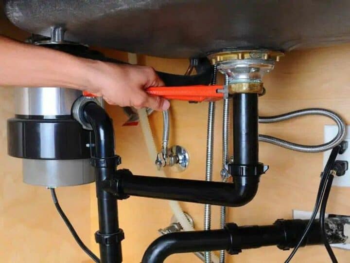 how to plumb a kitchen sink with disposal and dishwasher - plumber fixing kitchen sink