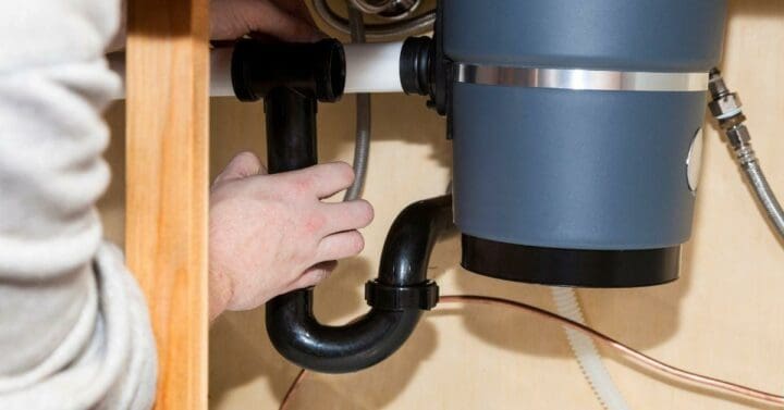 how to plumb a kitchen sink with disposal and dishwasher - plumber installing garbage disposal in kitchen sink